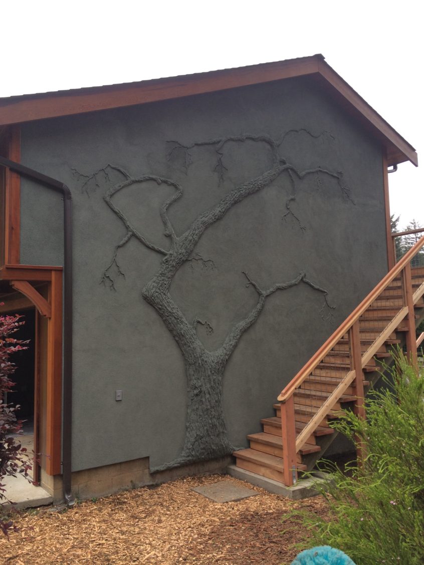 A house with tree-shaped decorative stucco siding